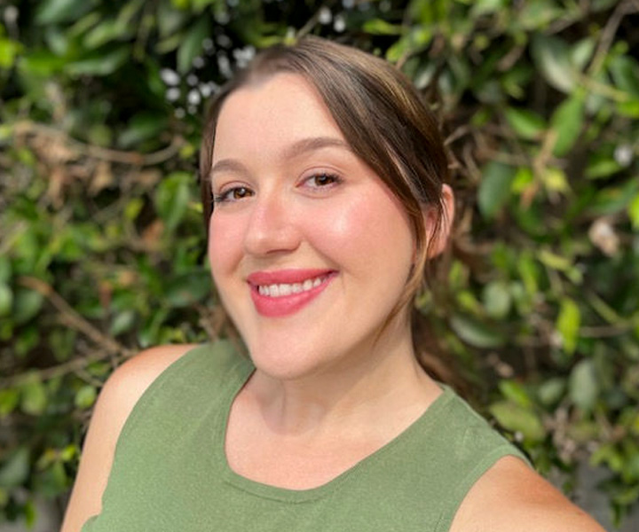 Julia Silver posing for a photo with plants in the background.